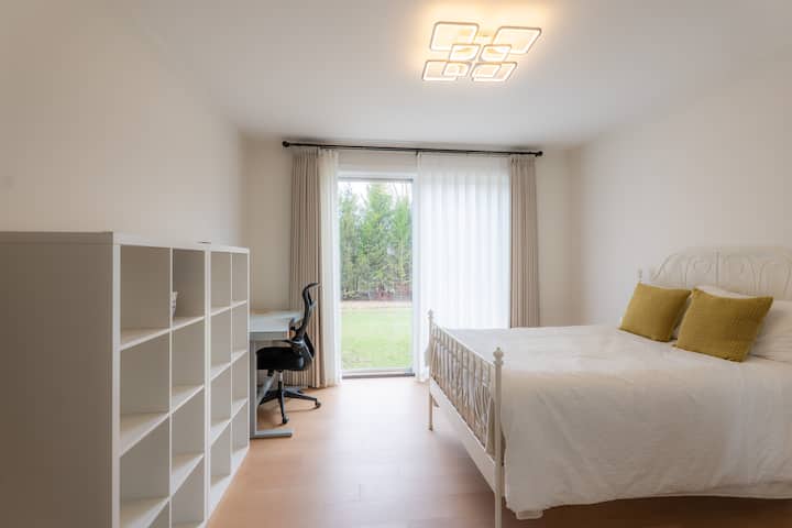 Den with a double bed, desk, and large wardrobe, ideal for work or extra guests