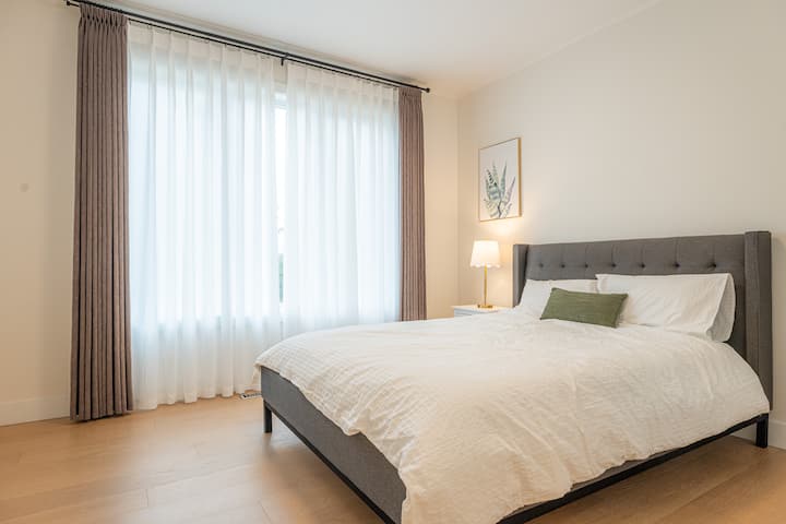Bedroom – 12'-8" x 11'-2" – A bright and airy room with a large window, comfortably accommodating a queen-sized bed