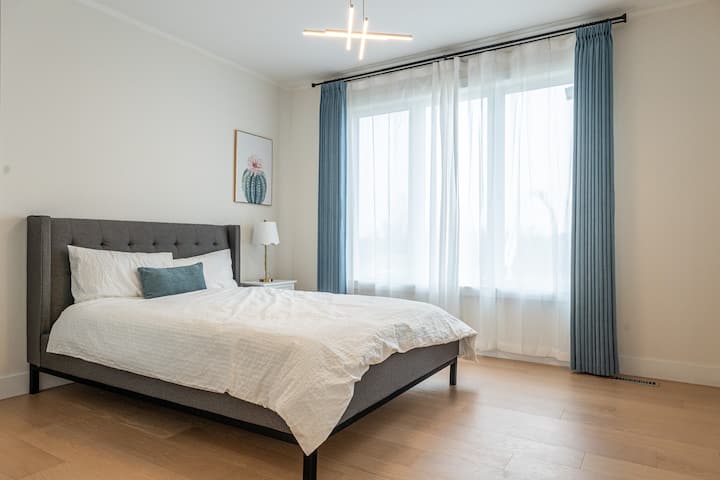 Bedroom – 12'-8" x 11'-2" – A bright and airy room with a large window, comfortably accommodating a queen-sized bed
