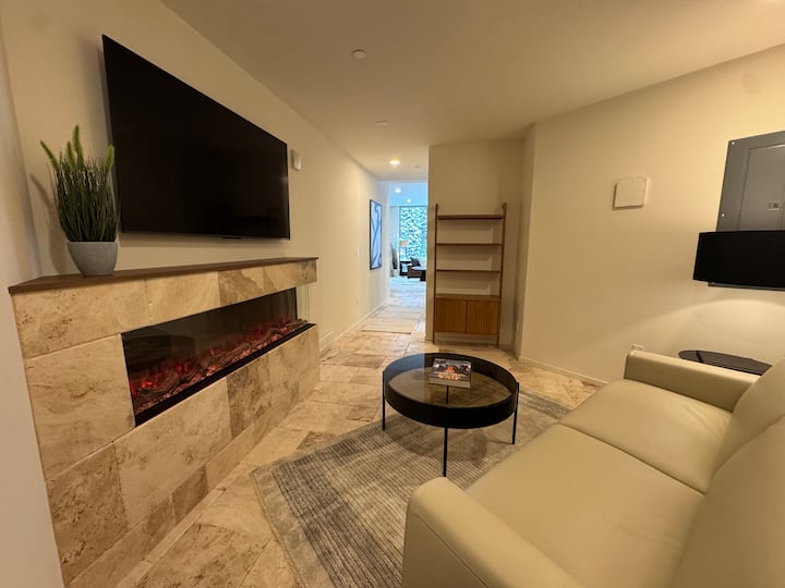 Enjoy this versatile space -- utilize as a den or secondary bedroom. Featuring Italian Leather sectional with Queen pull-out bed, electric fireplace, and 55" smart TV. Adjoining bathroom with luxury stone steam shower.