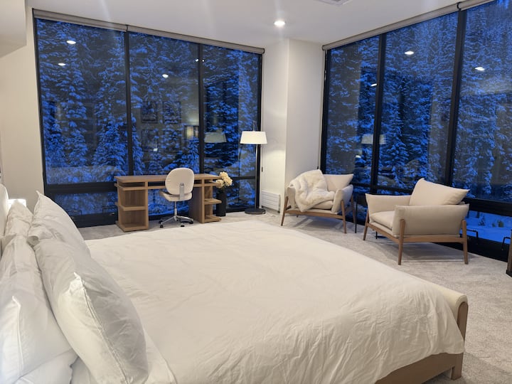 Sleep in absolute comfort on a king bed with floor-to-ceiling windows looking down at the ski slope and Winter Park Resort Base below. 