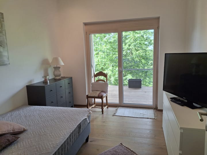 Eins der zwei Schlafzimmer im unteren Bereich. Zugang zur 2. Terrasse