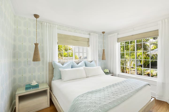 “Garden” master bedroom: wake to birds of paradise views in your KING bed — Saatva mattress, Smart TV, sleep machine, & blackout shades.