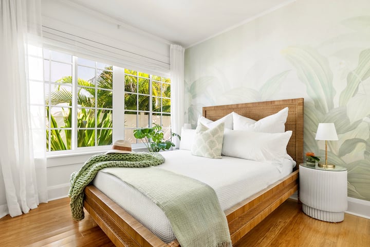 “Jungle” bedroom - serene tropical mural, luxe QUEEN bed, botanical views, smart TV, luxe linens, sleep machine.