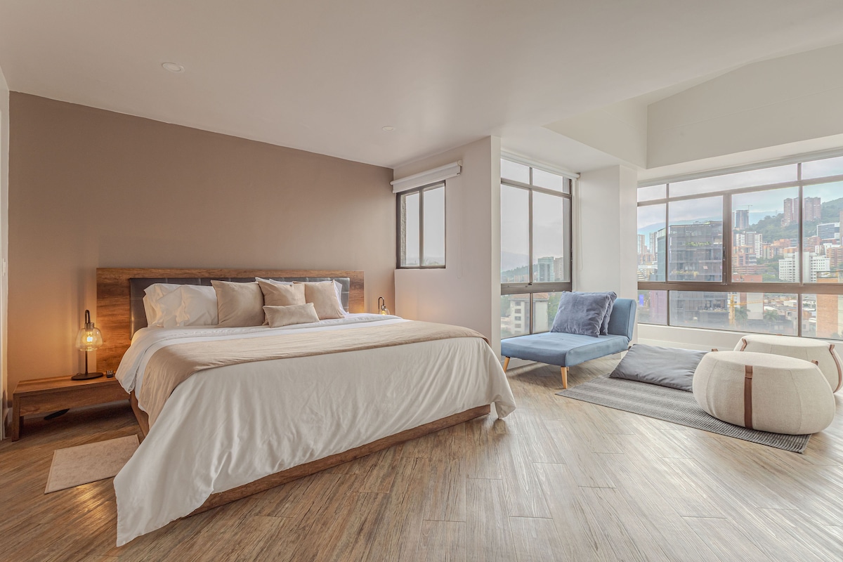 Master bedroom with king bed, walk-in wardrobe and city views