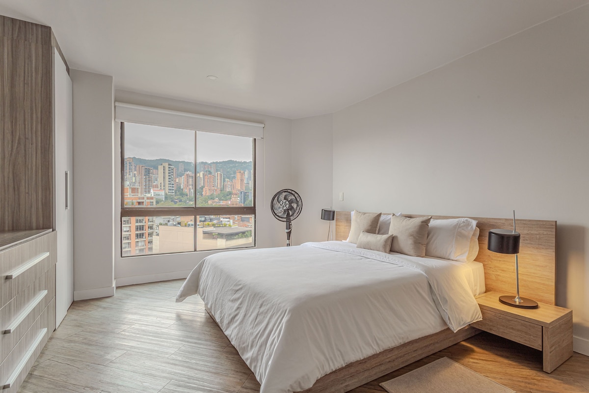 Bedroom with queen bed and city views