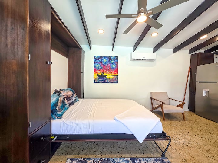 The living room can serve as an enclosed entertainment space or as additional guest accommodations with the bed as shown. 