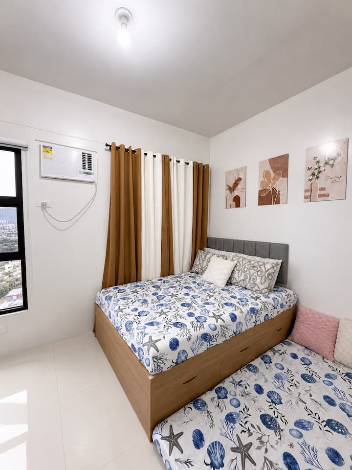 Comfortable and cozy bedroom with natural light, cool air conditioning, and a spacious wardrobe perfect for resting after a long day ✨ Can accommodate up to 6 pax, we have one double bed and two extra mattresses!