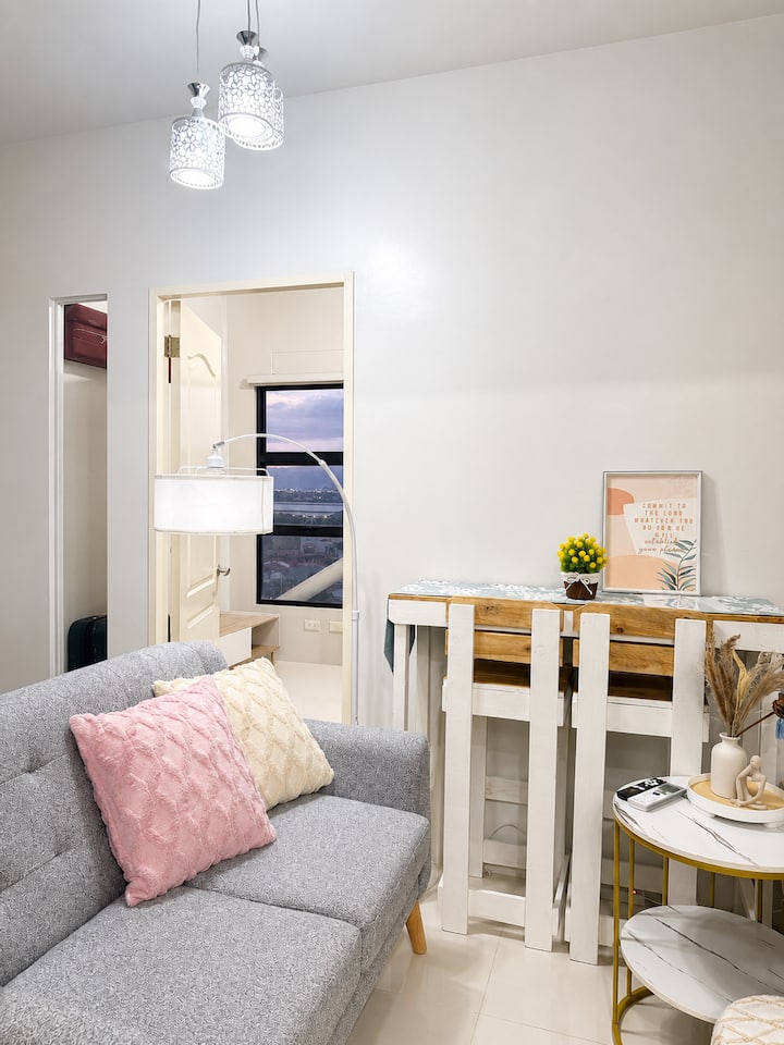 Relax in our cozy living room with a comfortable sofa, 55” Smart TV, Netflix, fast Wi-Fi, karaoke, Bluetooth speaker, and board games—perfect for movie nights, singing, or spending quality time with family and friends after a day of exploring.