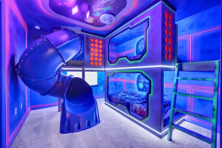 Star Wars themed kids bedroom with gorgeous hand painted murals and a slide for endless fun!