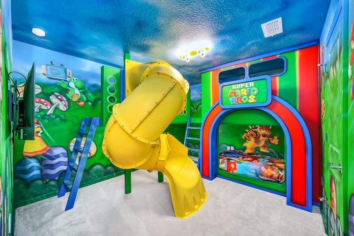 Mario Bros themed kids bedroom with gorgeous hand painted murals and a slide for endless fun!