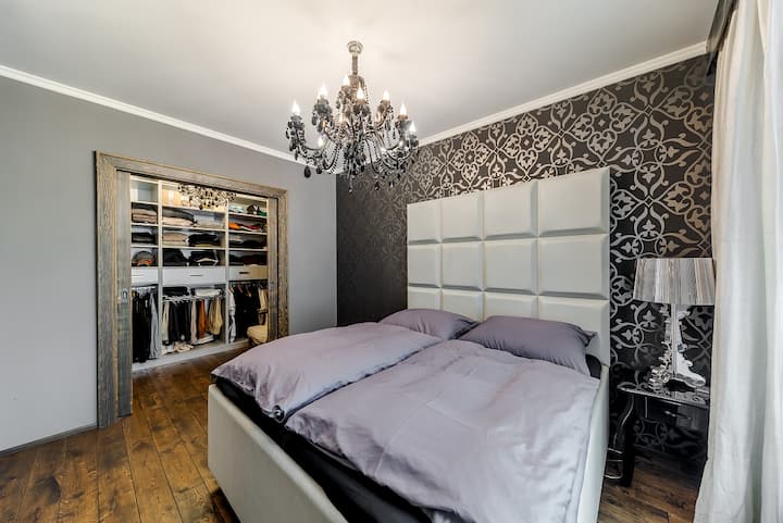 La chambre principale avec un lit king size et un placard