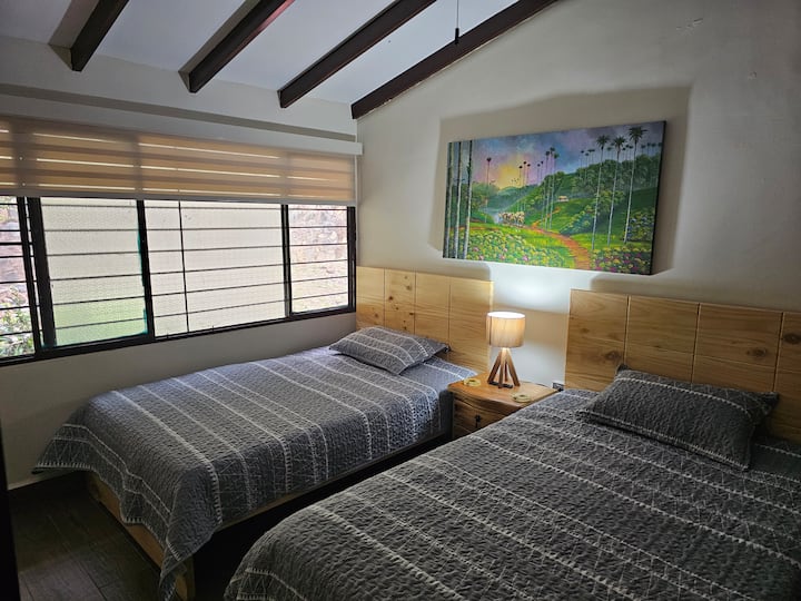 The fourth level houses two spacious bedrooms; each with its own 55" Samsung Smart TV and fan. These two rooms share an easily accessible bathroom located in the central hallway of the apartment, offering comfort.