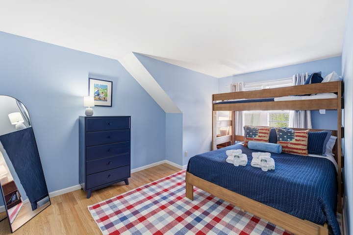 This bright blue retreat features a twin-over-queen bunk bed that makes sleepovers feel like an adventure