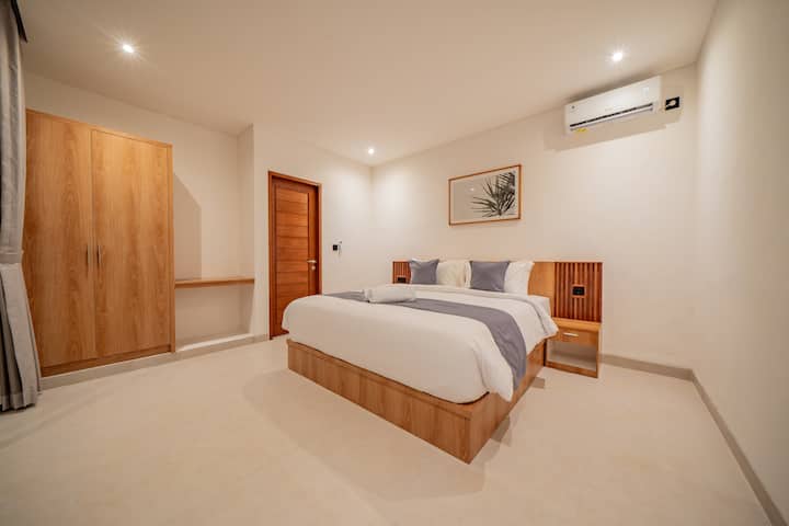 Comfort and convenience on the second floor. This room includes an elegant wooden wardrobe, a side table, and individual AC for custom temperature control. ️