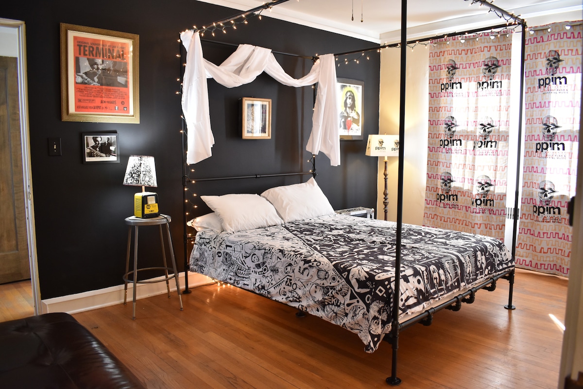 Master bedroom with custom industrial four-poster bed — quiet, comfortable, and thoughtfully designed.
