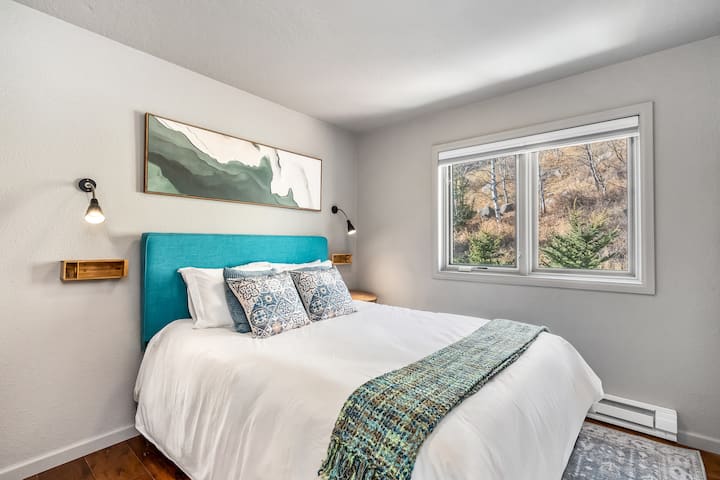 The secondary bedroom has a queen sized bed, is wonderfully styled and has a cozy feel. The full bathroom is just steps away in the hallway.