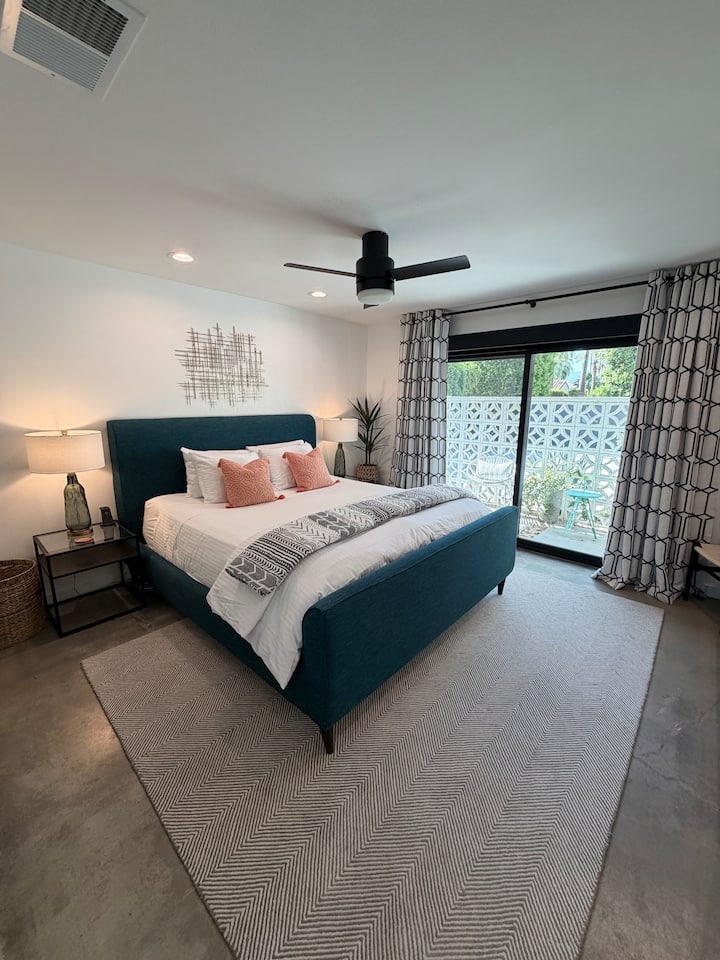 Wake up to sweeping mountain views framed by iconic midcentury breeze block from your private patio, or lower the electric blackout shades for a restful night. Thoughtful touches—sound machine, phone chargers, and ceiling fan—ensure ultimate comfort.