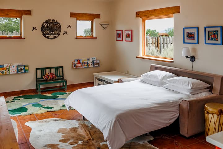 A premium American Leather queen sleeper sofa with an organic topper and bedding - offering ultimate comfort and flexible sleeping arrangements. Located in the casita, this charming pass-through room leads to the second master suite.
