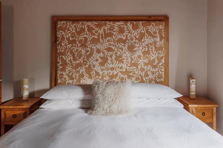 Sleep peacefully on this luxury California king organic bed and premium bedding, beneath a custom Otomi textile headboard - crafted with care, rooted in tradition.