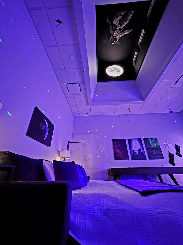 Sleep beneath the stars on our comfy sofa bed, set under the floating astronaut and glowing moon.