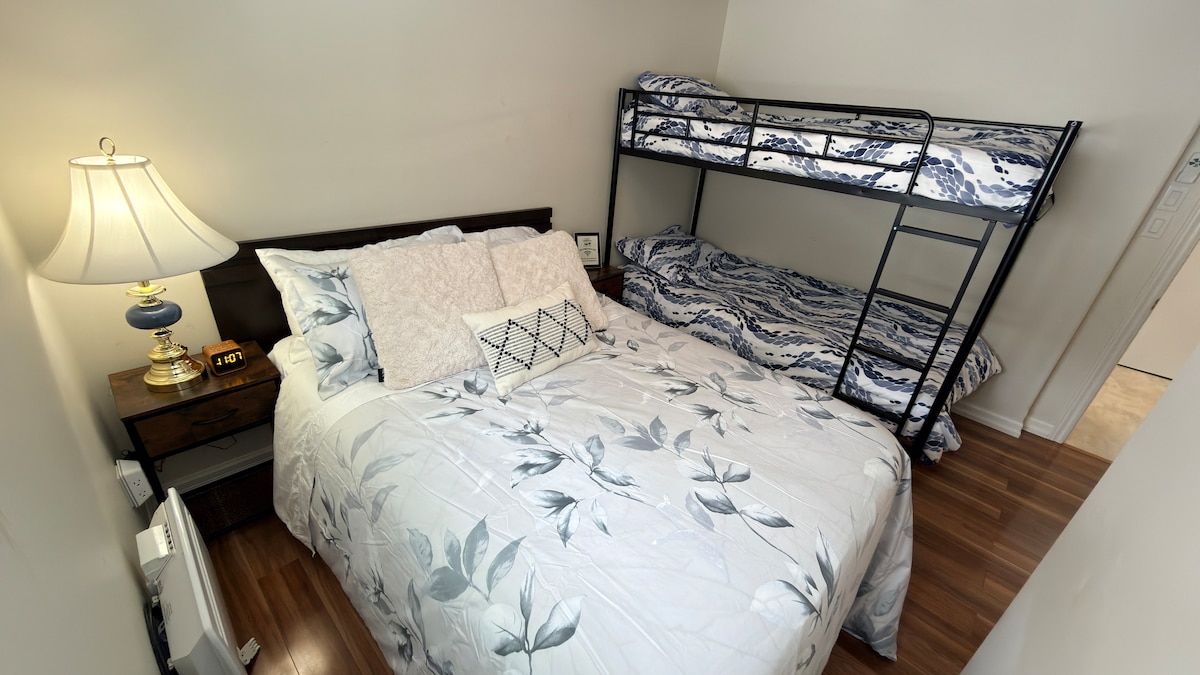 Family-friendly bedroom with a double bed and twin-over-twin bunk—perfect for kids or extra guests.