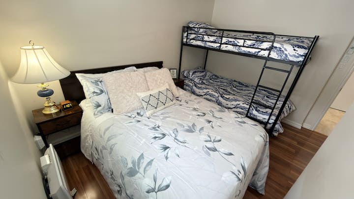 Family-friendly bedroom with a double bed and twin-over-twin bunk—perfect for kids or extra guests.