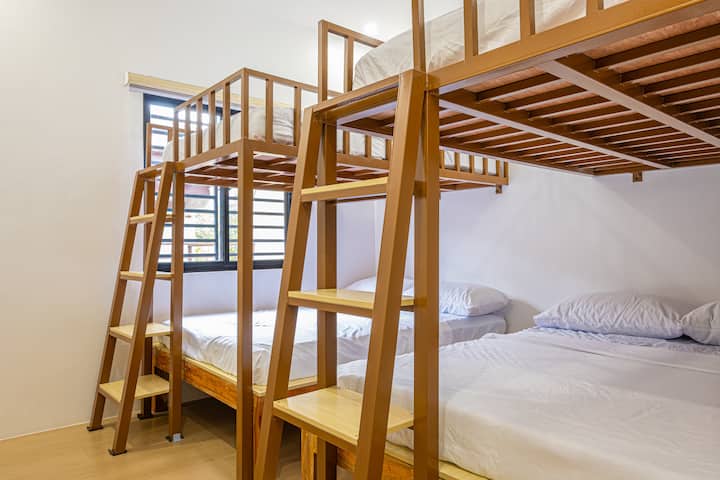 Two bunk beds, each with double-size mattresses