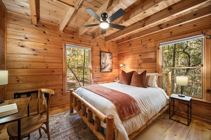 The first main floor bedroom features a queen-size bed, a desk, and ample storage space for your stay.