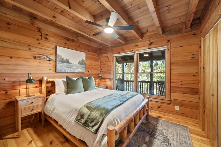 Second main floor bedroom with queen bed, mountain views, closet with dresser, and TV (not pictured).