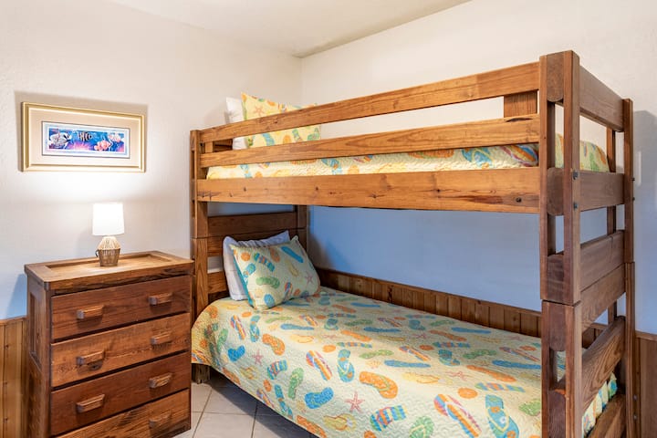 Two sets of twin bunk beds. Small dresser and closet.