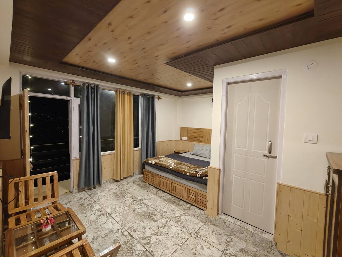 Guest enjoying snow-capped mountain view from Hils & Paw garden fence