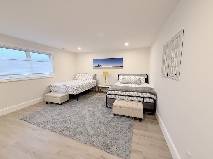 First floor bedroom complete with two cozy queen beds. Additional queen air mattress and bedding are located in the closet.