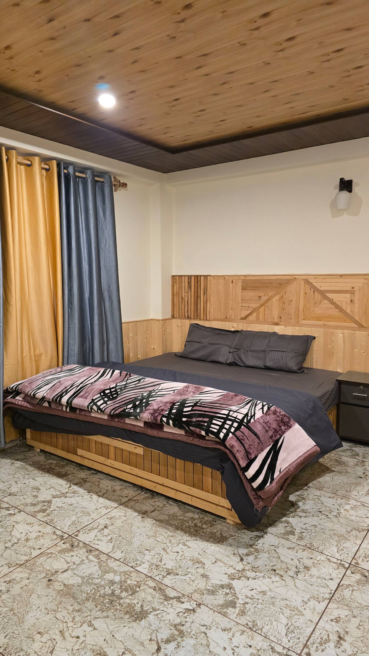 Tree in the foreground with Hils & Paw building and outdoor seating behind