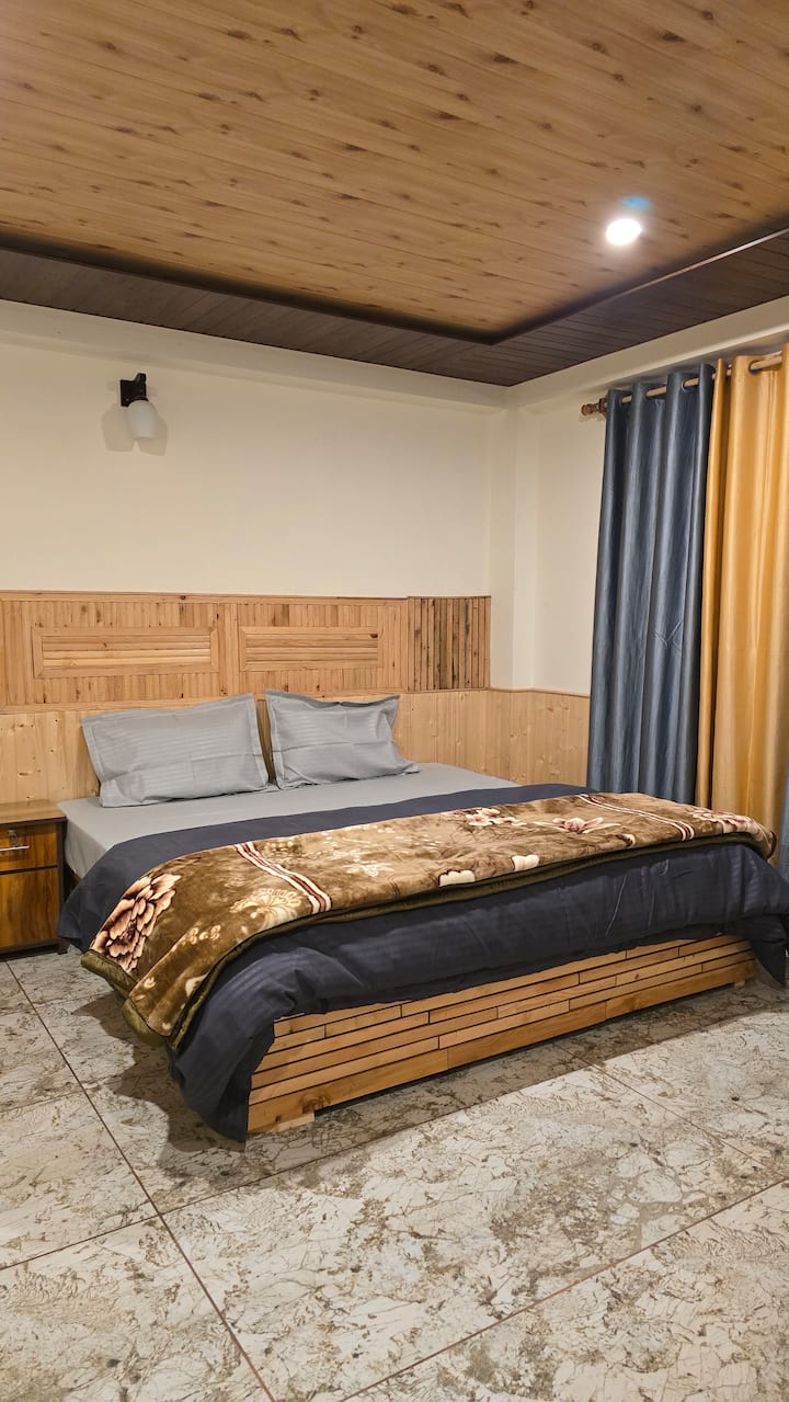 Hils & Paw garden, fenced lawn, and building exterior surrounded by trees