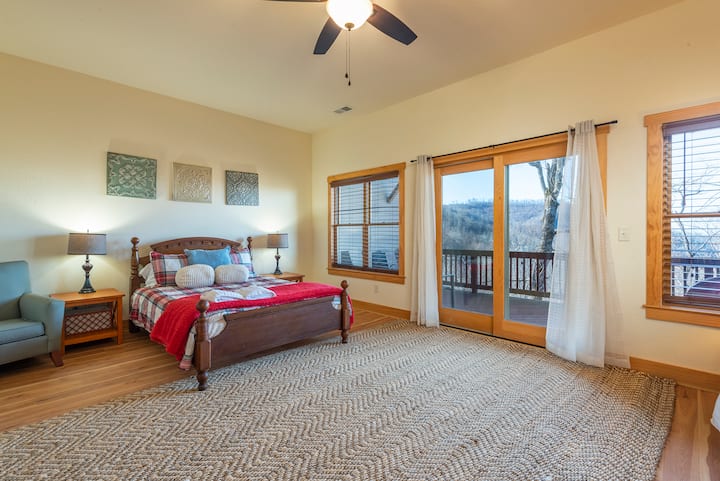 This queen bed is located on the lower floor with a private deck and an additional bunk bed in the room as well.