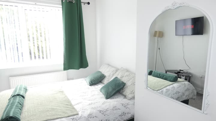 Spacious master bedroom: double bed, fresh bath sheet towels, and vertical blinds for added privacy