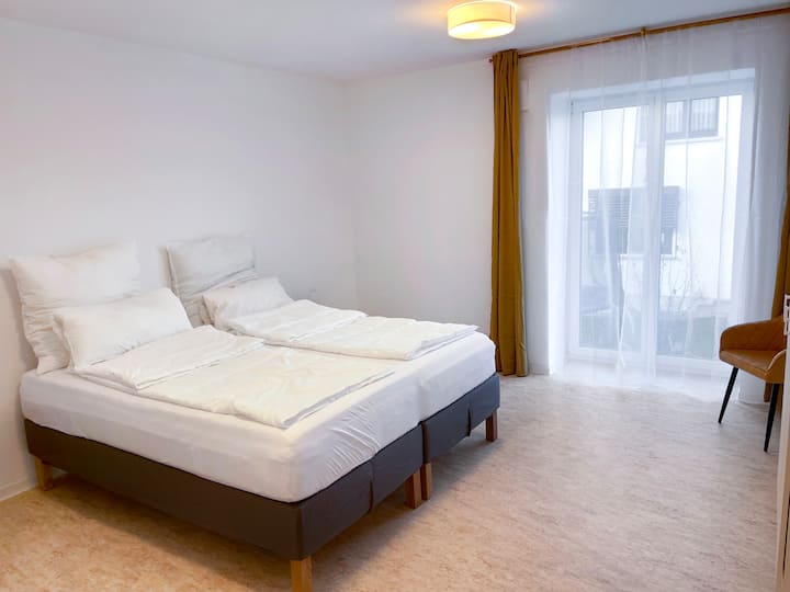 Bright bedroom featuring two single beds and modern finishes