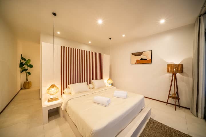 Peaceful master bedroom with a king-size bed and terrace view.