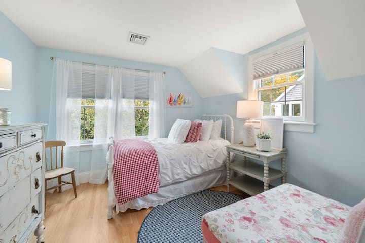 2nd floor bedroom with twin bed, seating area, and small closet.