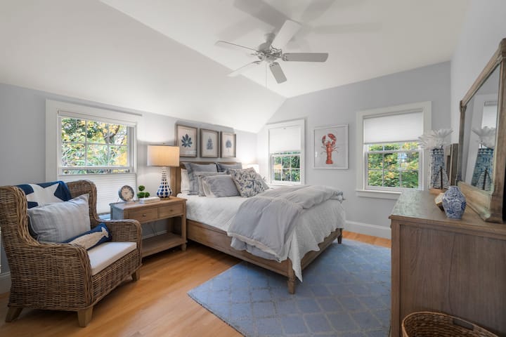 Carriage house 2nd bedroom with queen bed, closet, and dresser for comfort.
