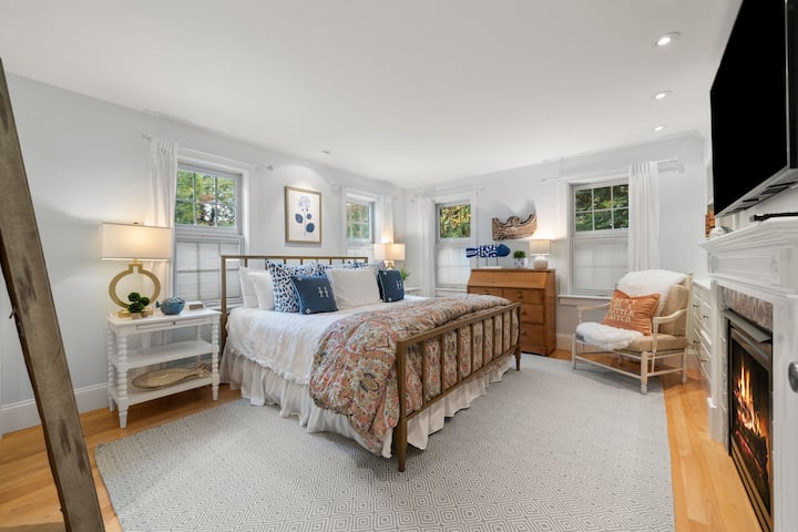 1st floor bedroom with fireplace, full mirror, dresser, king bed and direct connection with full bathroom.