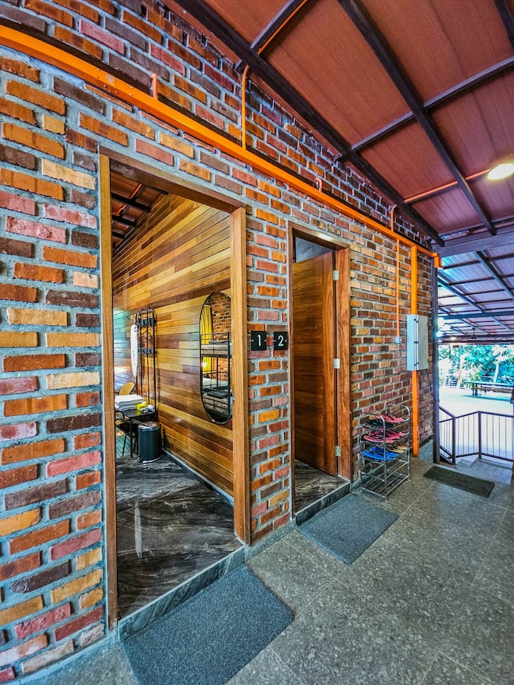 Welcome to The Sanctuary. The industrial-rustic design flows right to your door with exposed brick and warm wood accents. Rooms 1 and 2 are ready for you—just kick off your shoes on the rack and step inside!