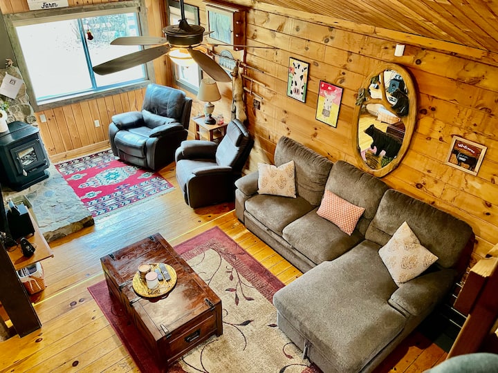 วิวห้องนั่งเล่นจากเตียงลอฟท์ ปลายโซฟาที่เล็กกว่าดึงออกมาให้ตรงกับความยาวของเลานจ์เก้าอี้