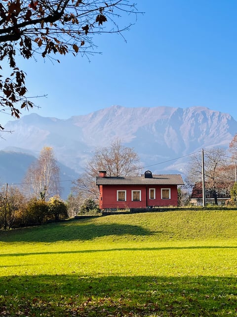 Red villa with porch and garden
