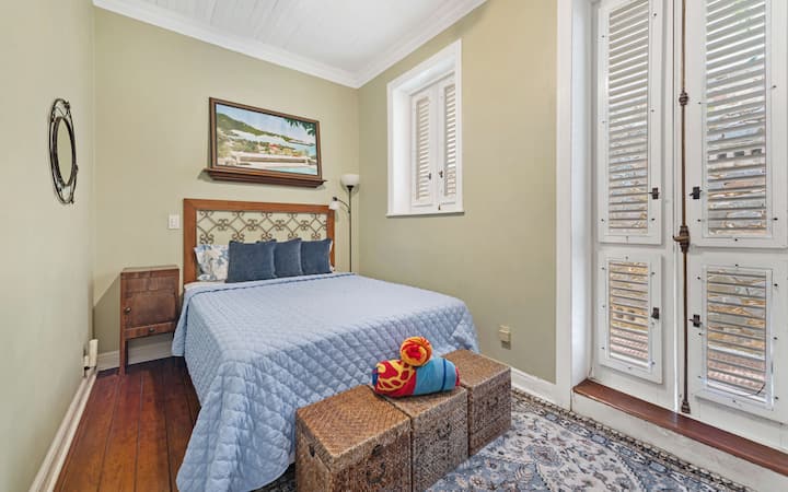 Bright queen bedroom located in the main house, perfect for resting after island adventures.