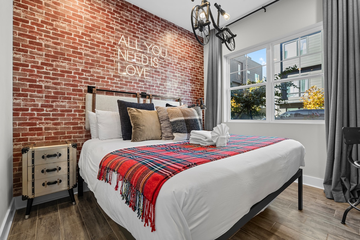 Bedroom with boutique hotel feel and a fun pop of color from the plaid accents.
