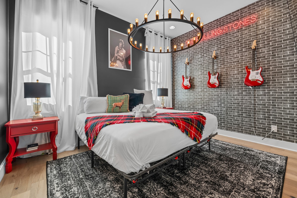Music-city style bedroom with statement lighting and playful wall art