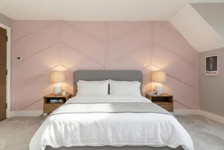 Stylish bedroom featuring a comfortable super-king bed, soft lighting, and modern décor. A cosy and inviting space designed for a relaxing stay and a restful night’s sleep.
