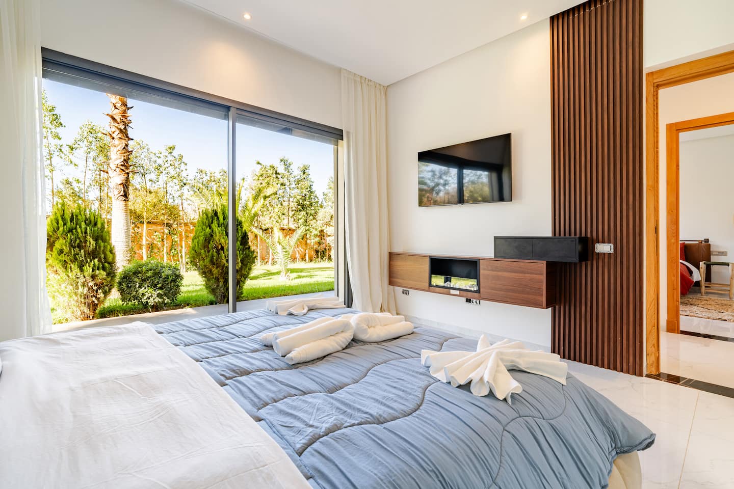 Bedroom of a managed villa opening onto its garden